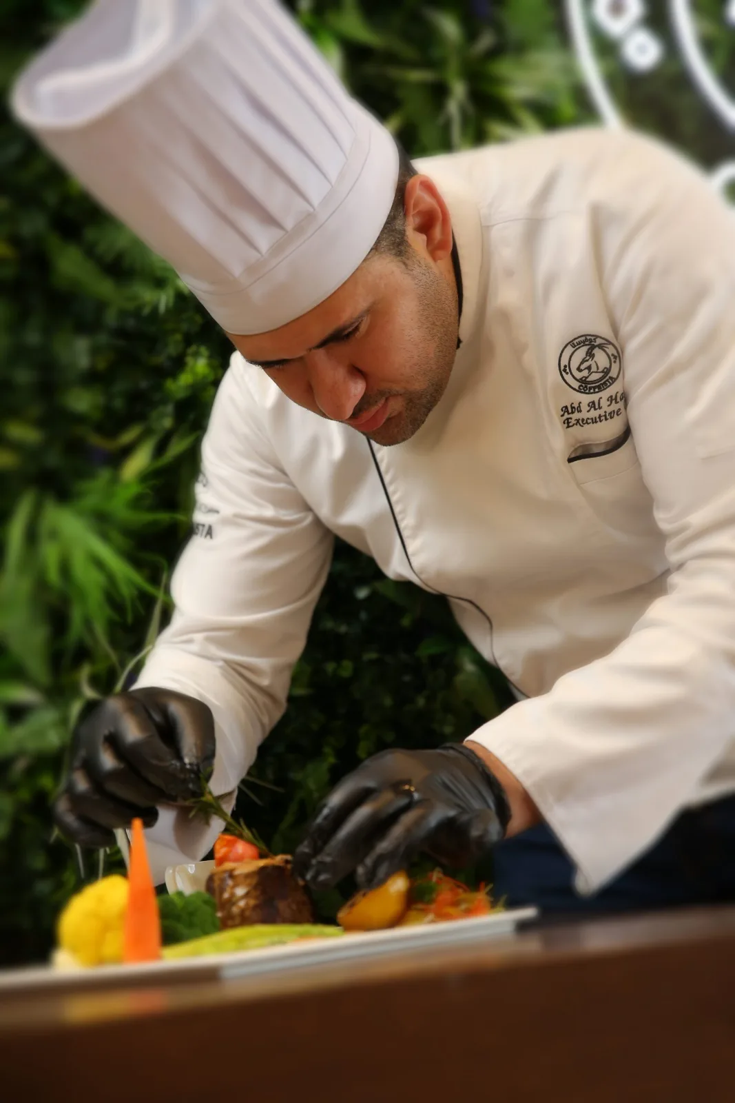 Coffeista executive chef plating a dish